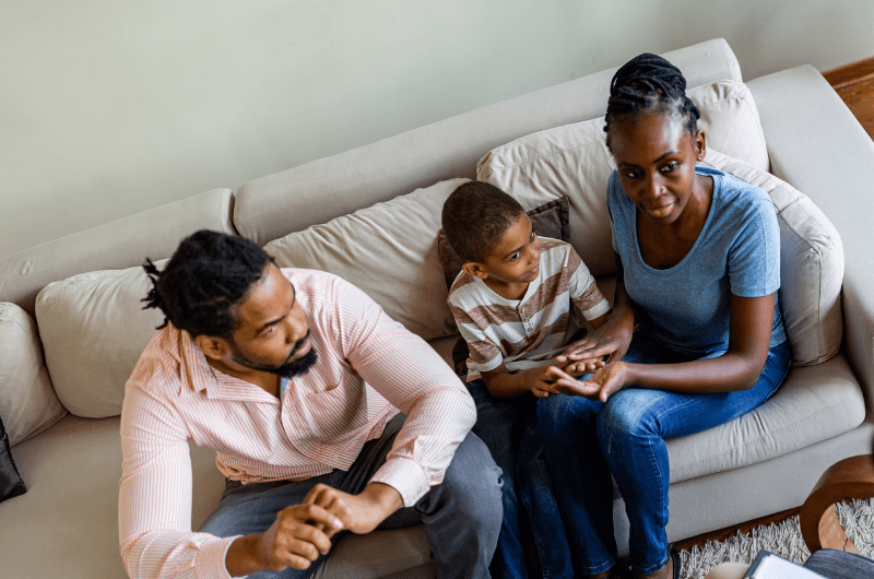 a family of three sitting in therapy