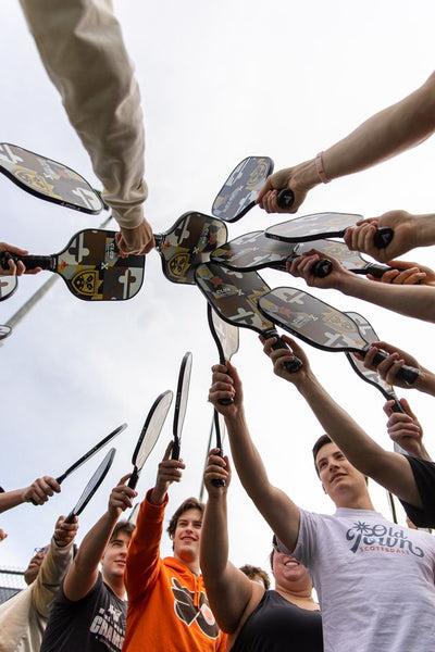 transfer students put their pickleball bats together
