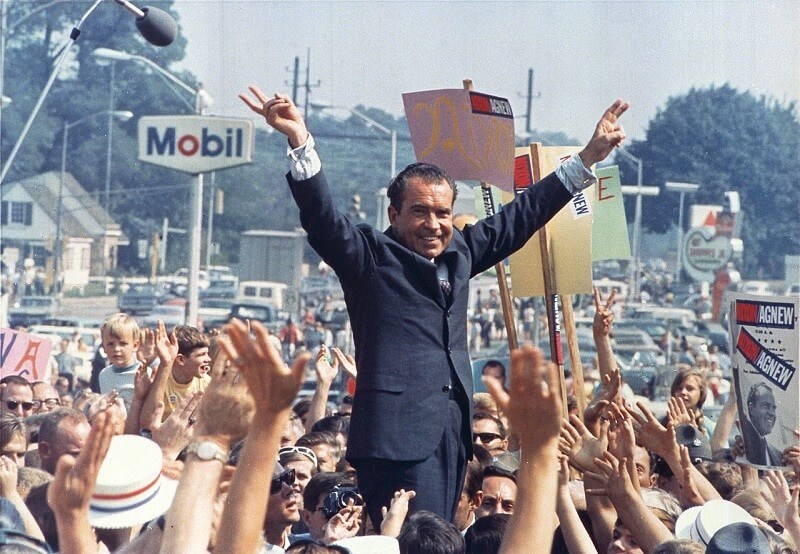 Nixon surrounded by people cheering him on 