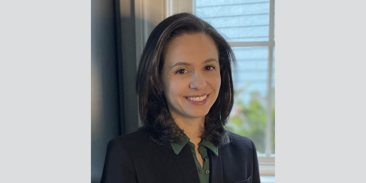 Caucasian woman with dark hair in business attire