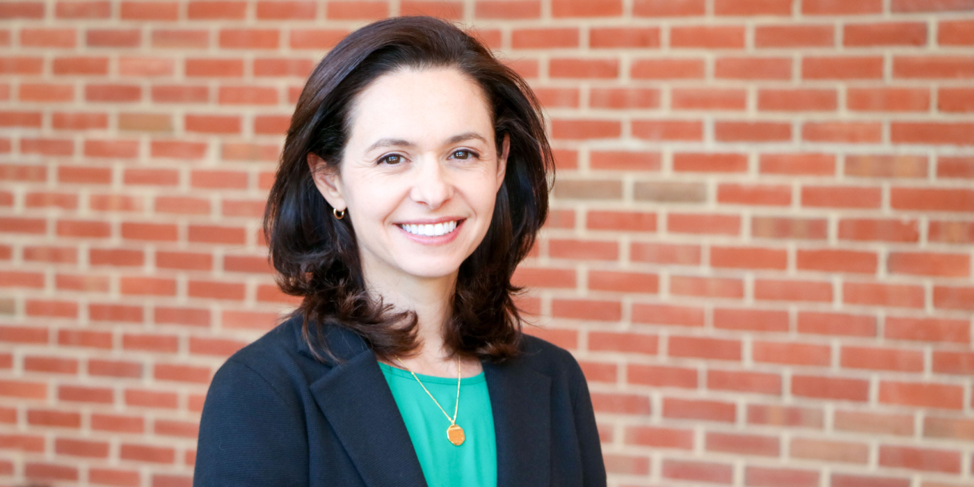 Caucasian woman with brown hair in business attire