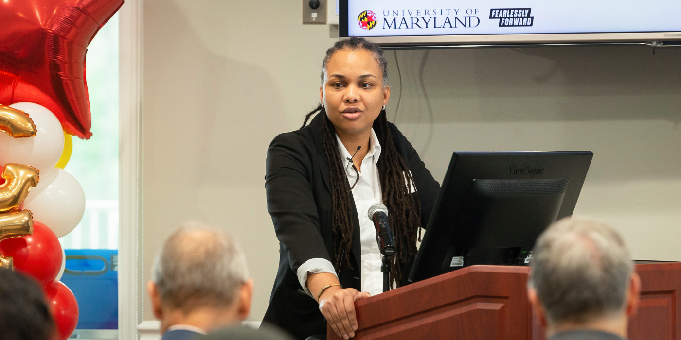 Graduate Joanne Perodin speaking at the podium