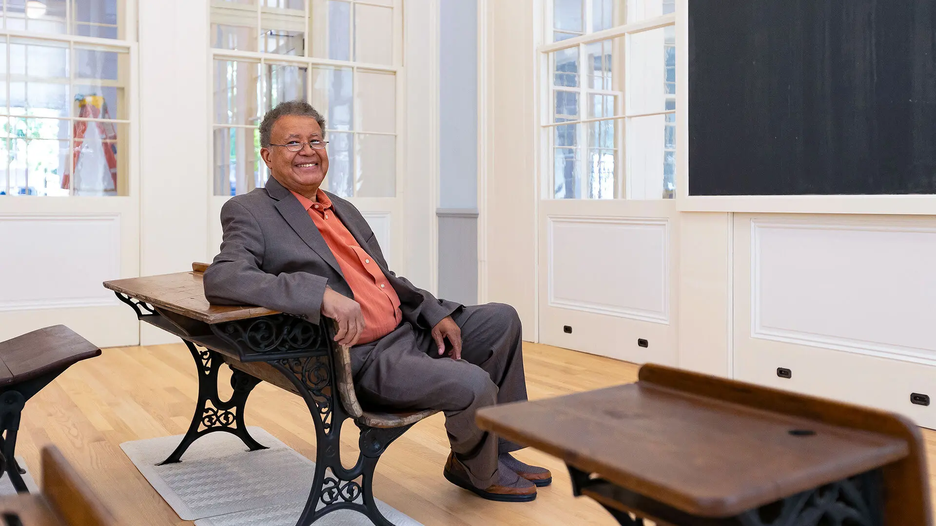 Retired US District Court Judge Alexander Williams seated in restored classroom at the new Thurgood Marshall Amenity Center in West Baltimore