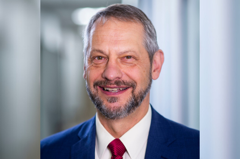 Male in blue suit with white shirt and red ties