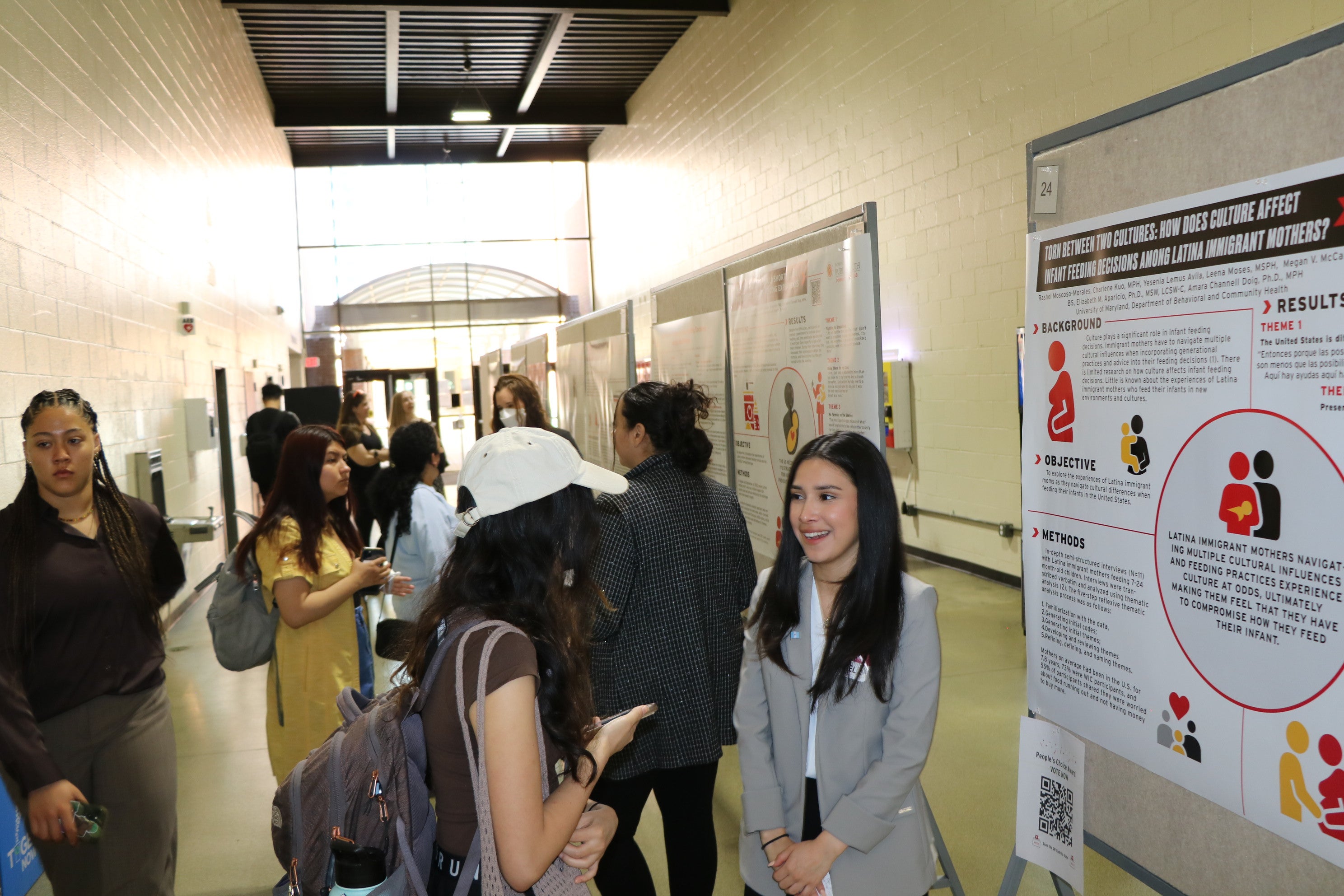 female student explaining her poster presentation