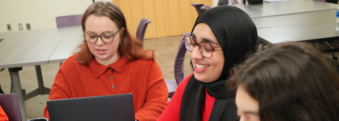 students in a classroom smiling