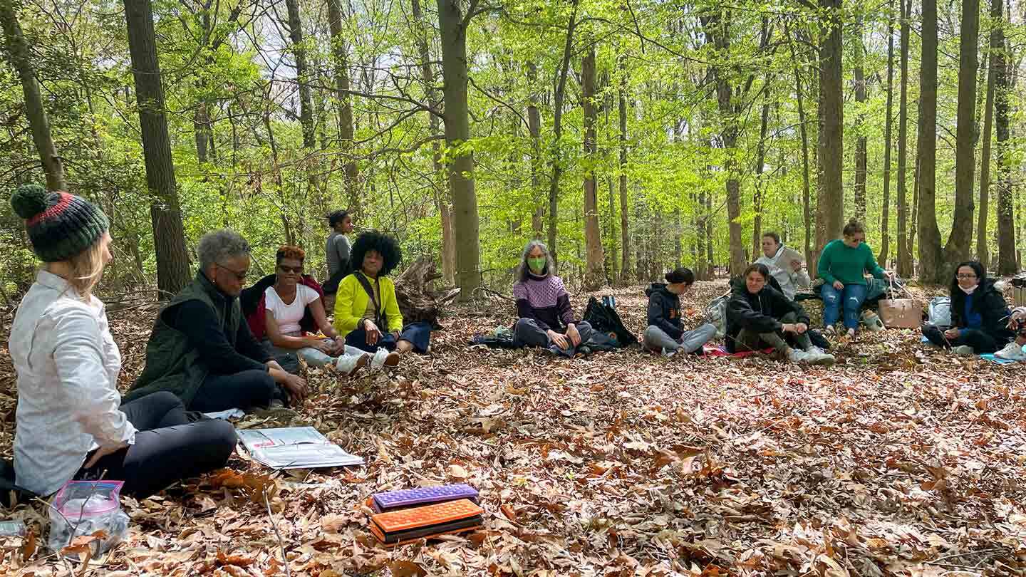 A group of people relaxing in a wooden area