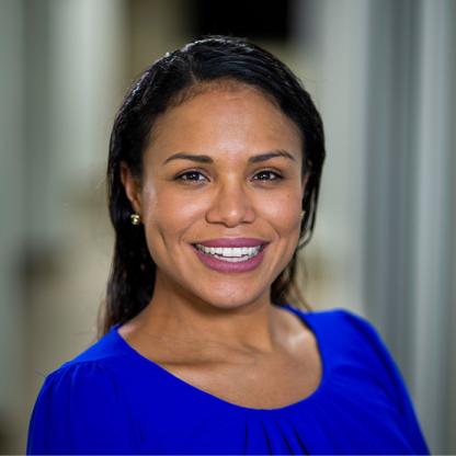 Rianna Murray, alumna of the School of Public Health at the University of Maryland with red background