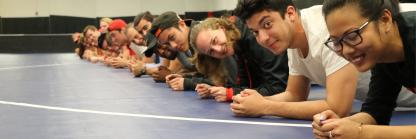 Kinesiology students in planking position at the SPH mat room.