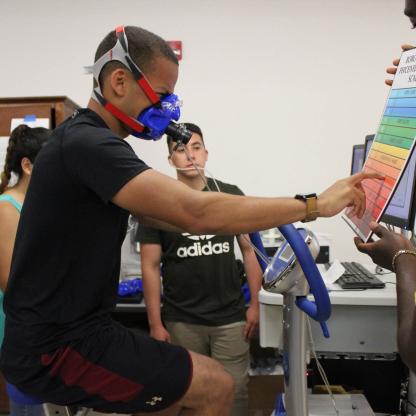 Kinesiology student riding a bike
