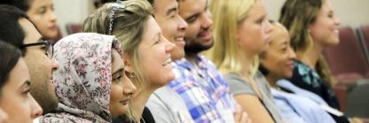Profile of MPH students in lecture hall smiling at the University of Maryland.