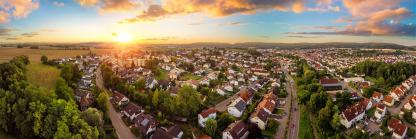 Aerial panorama of small town at sunrise.