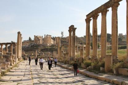 Picture of stone pathway and stone columns in Jordan with people walking