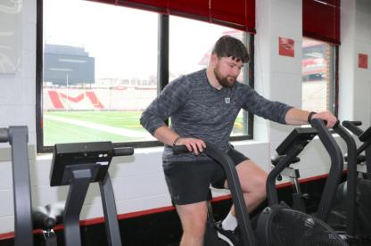 Person riding a stationary bike in a gym.