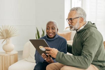 Couple using digital tablet on the couch