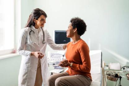 Female doctor with patient in an exam room