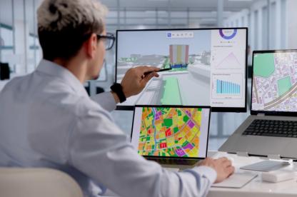 male professional looking at data on a computer screen