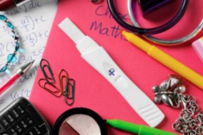 a pregnancy test sits among detritus of a teenage like a necklave, a cup