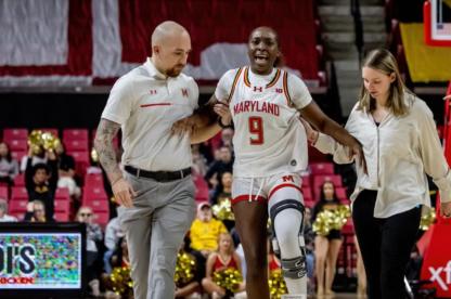 female student athlete being helped by coaches