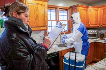 two students conducting water research inside a house
