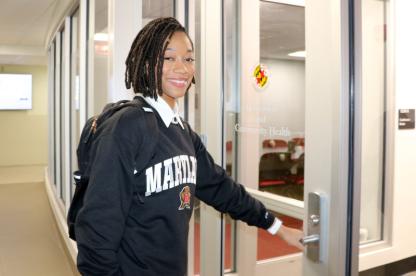female student opening door to office suite