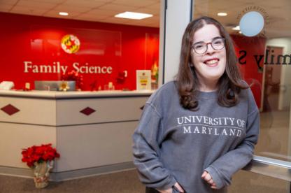 Female student standing outside of the department of Family Science