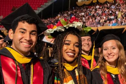 three students at graduation