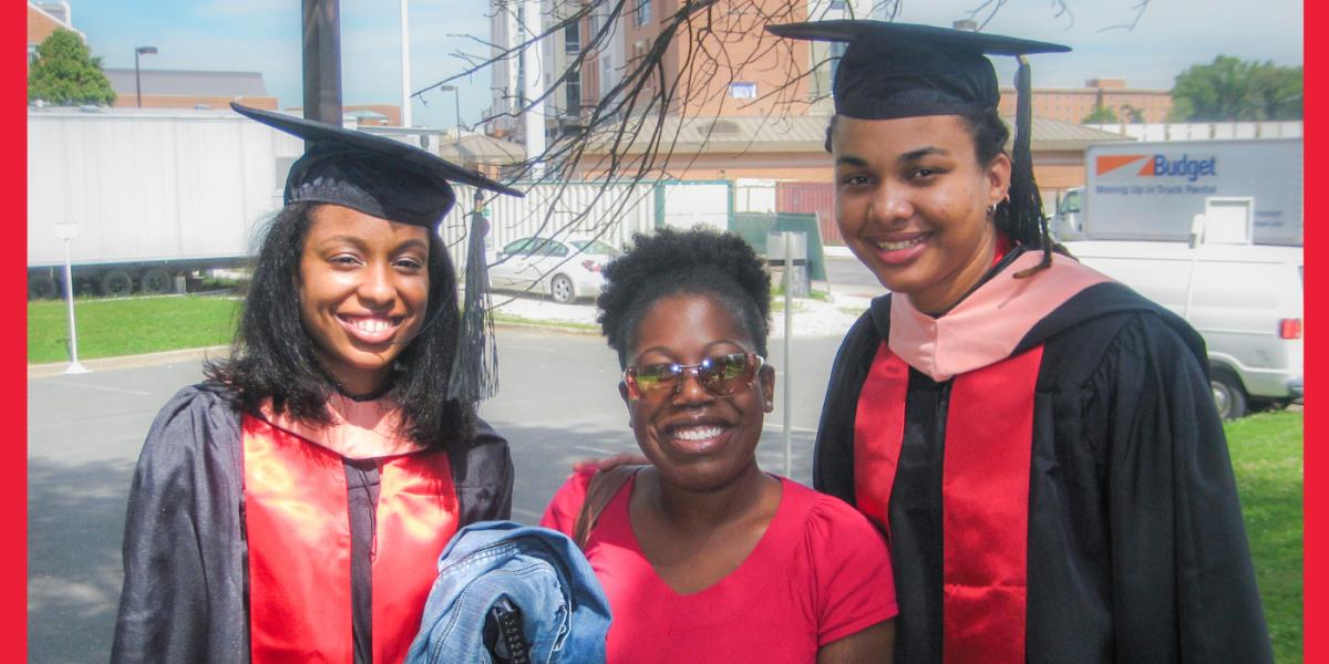 Three SPH students wearing graduation clothes smile to camera