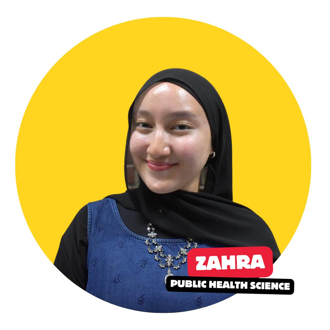 student smiling at camera with solid color background