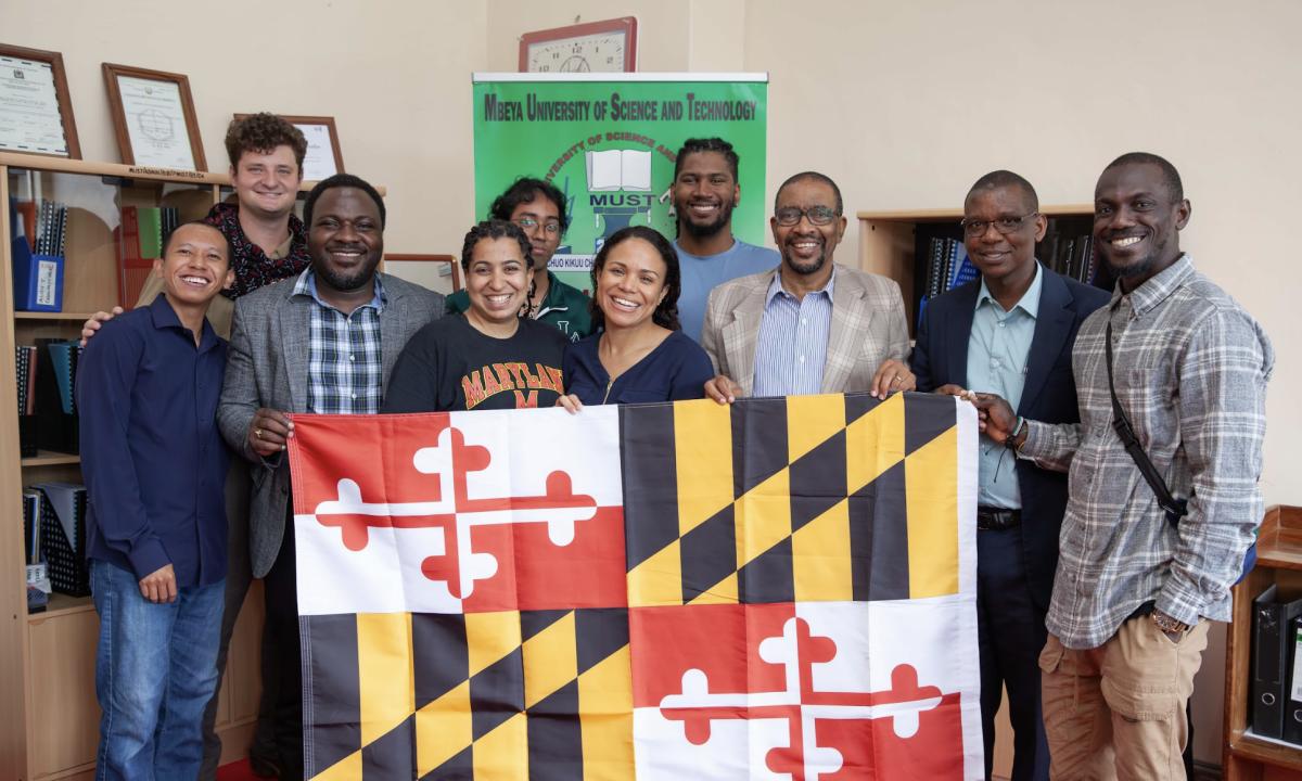 UMD group pose with flag at MUST