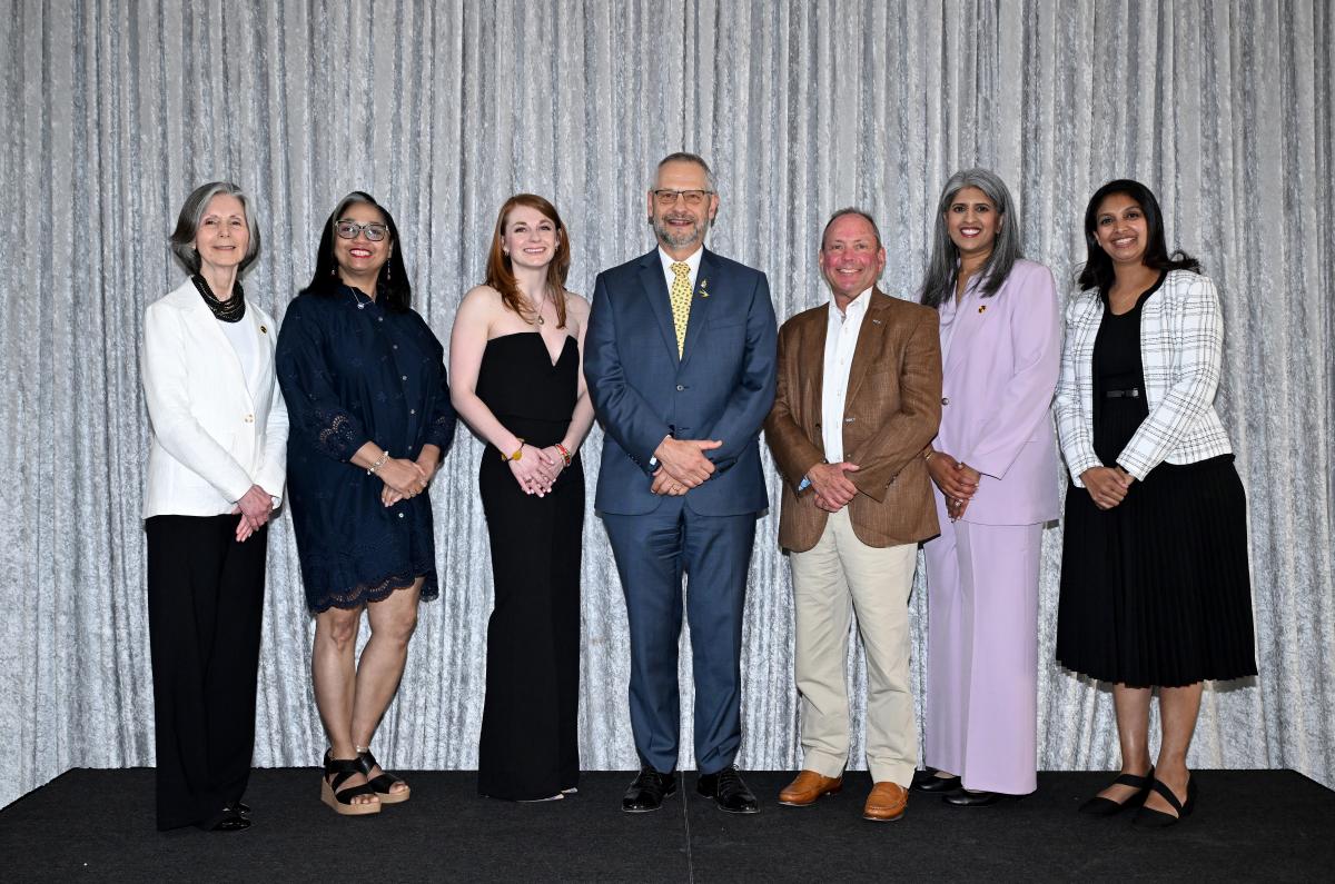 Group of Dean's Recognition awardees with Dean Lushniak smile at camera