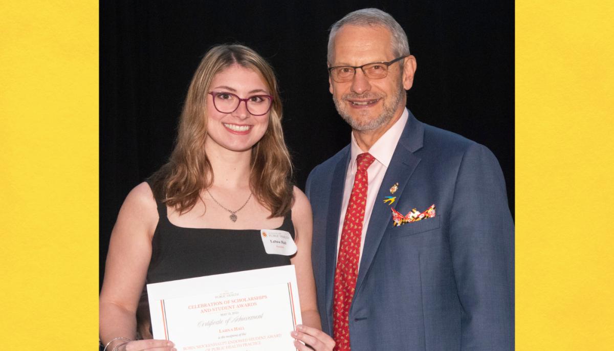 Female student posing with award certificate