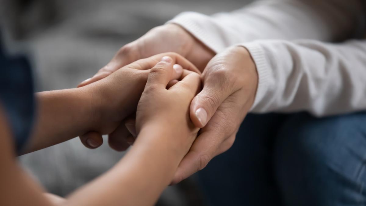 adult hands hold child's hands