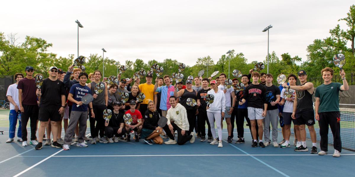 Group of students posing on pickleball court