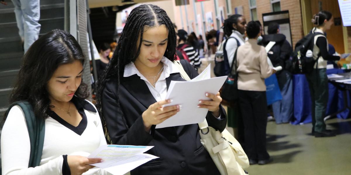 two students looking at their resumes