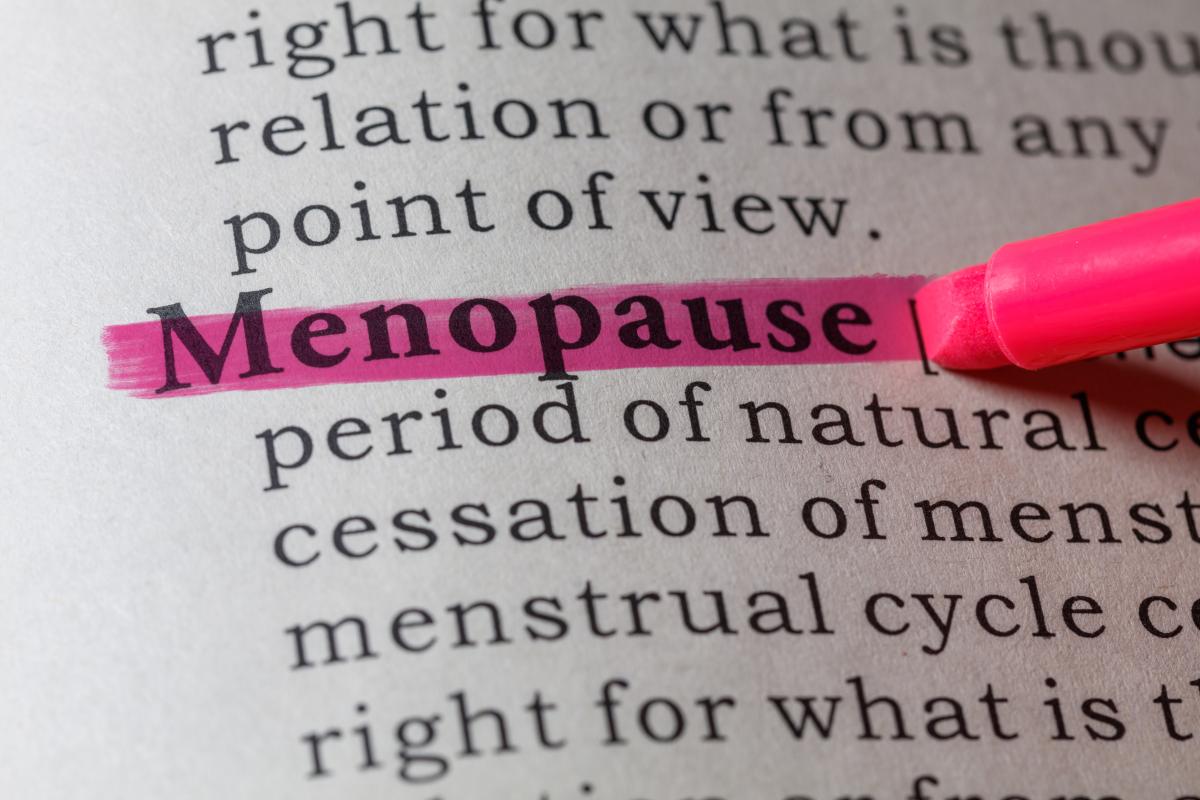 Photo of dictionary entrance for “Menopause” with pink highlighter pen highlighting the word