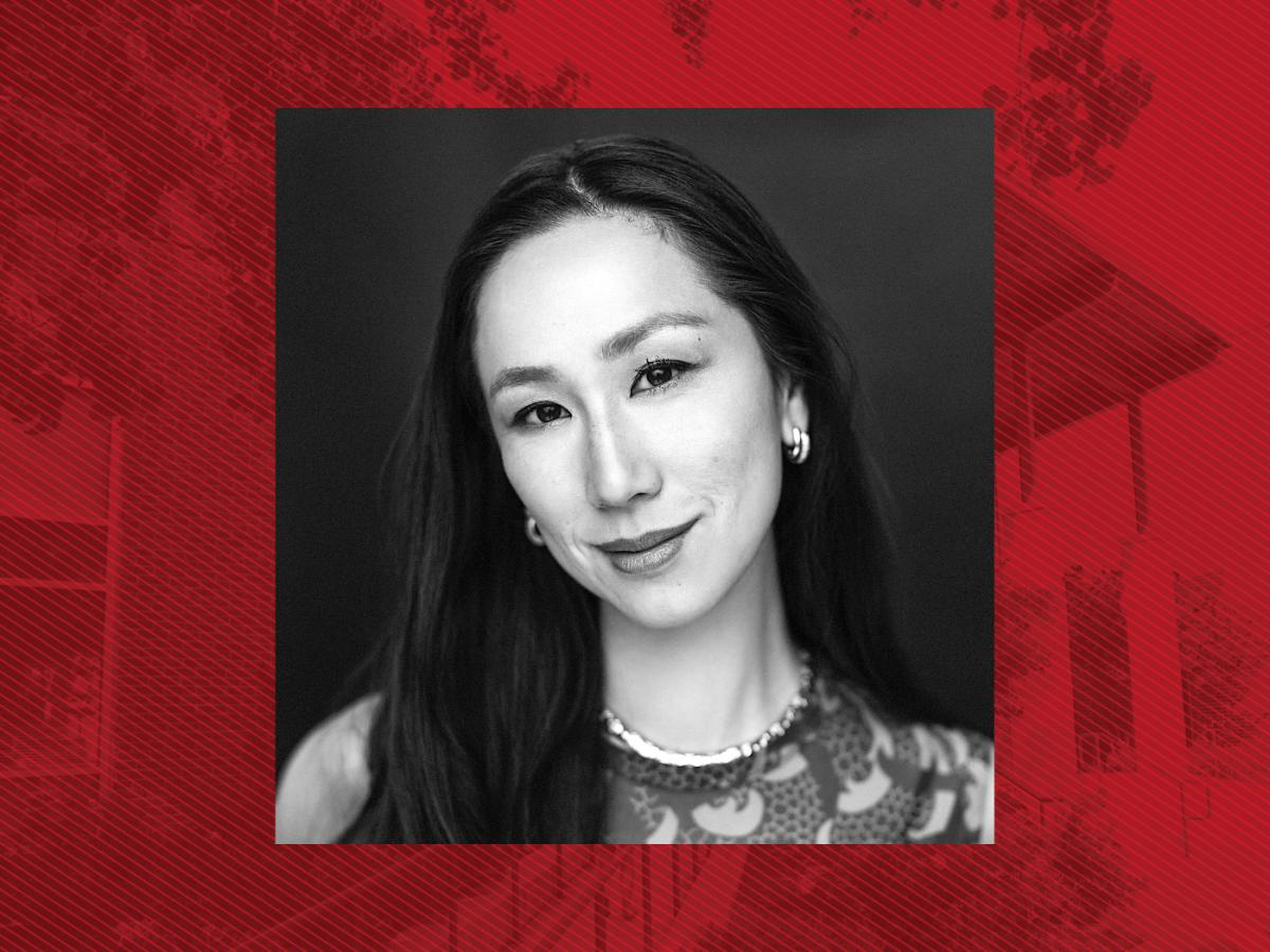 Black and white head shot of Asian woman with long black hair in a scoop neck top against a red background graphic of the School of Public Health