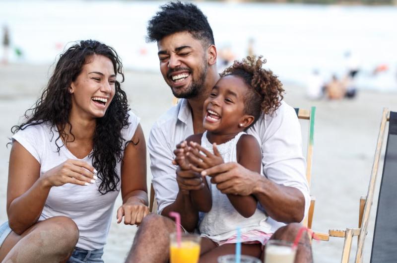 Family laughing on beach