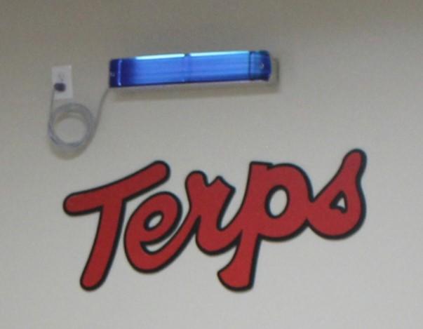 GUV fixture above a "Terps" sign on the wall