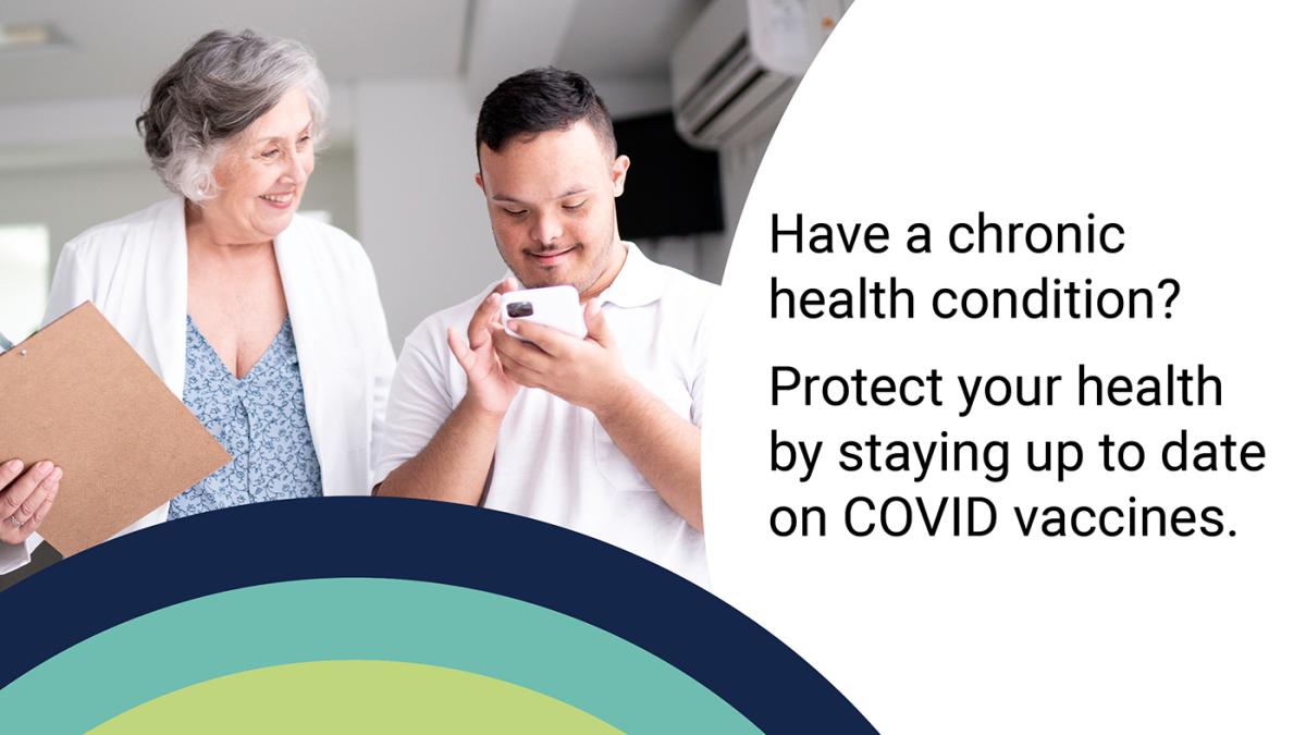 Stock photo of doctor holding a clipboard next to a patient with Down's Syndrome looking at a smartphone. Both people are smiling.