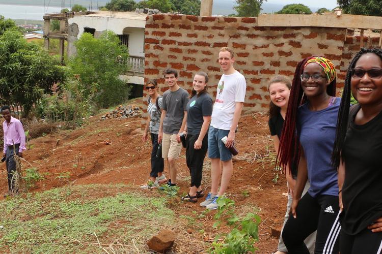 Diverse group of UMD students standing outside in a community in Sierra Leone