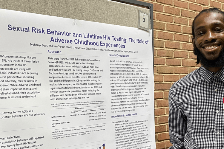 David Hawthorne poses with his poster during the 2022 UMD SPH Poster Session