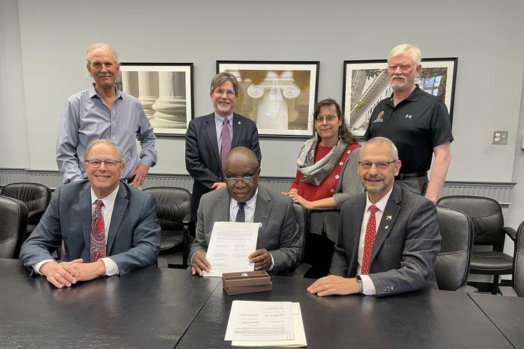 School of Public Health Dean Boris Lushniak (right) along with Dean Craig Beyrouty of the College of Agriculture and Natural Resources (left), signed a memorandum of understanding with Vice Chancellor Laban Ayiro of Daystar University in Kenya (center).