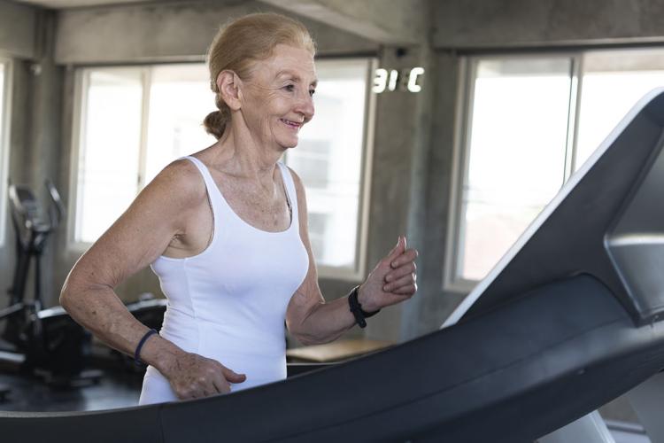 Senior women exercise jogging at gym fitness smiling and happ