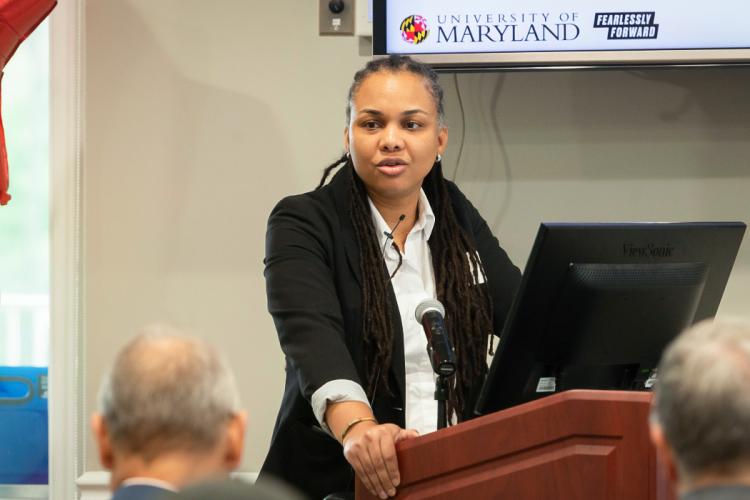 Graduate Joanne Perodin speaking at the podium