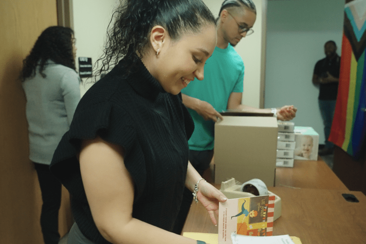 woman putting together a care package for new moms