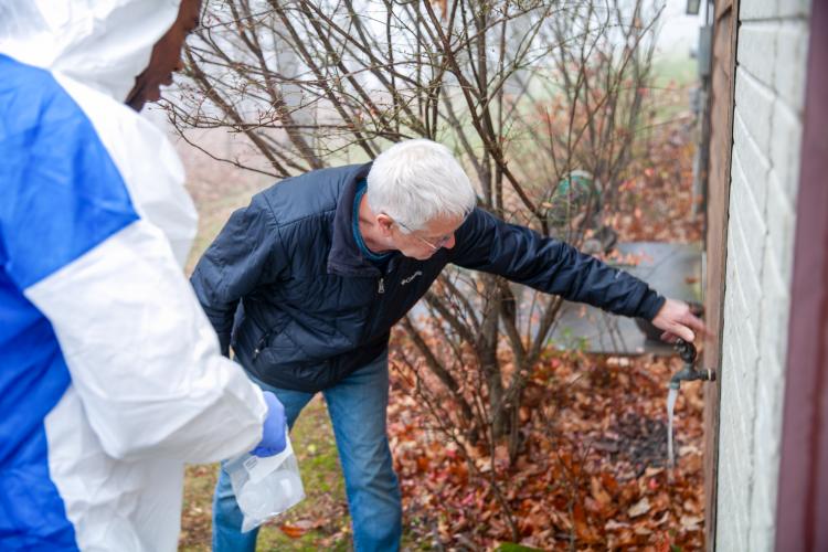 Man reaches out to turn on tap