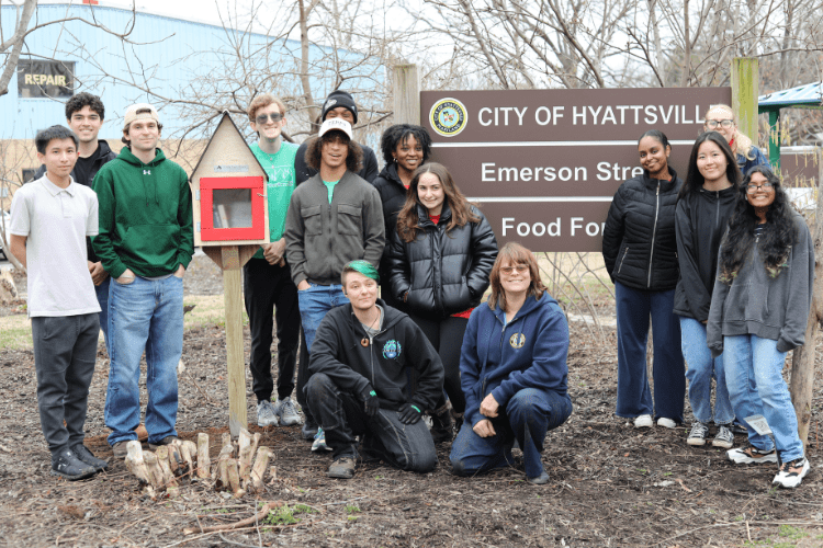 group of students pose in front of City of Hyattsville sign
