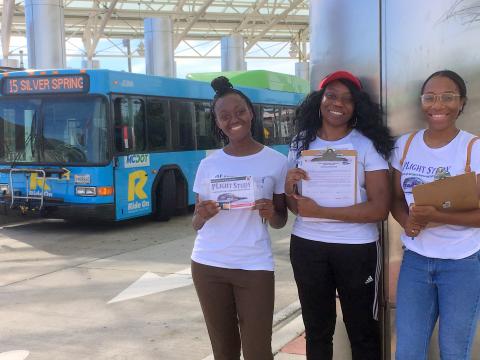 Jariatu, Faith and Aliyah, PLIGHT Study researchers, conducting transit stop interviews at the Langley Park Transit Center, July 1, 2019.