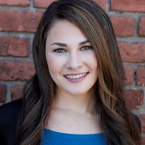 woman with long brown hair and blue shirt